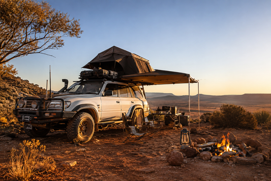 Loaded 4x4 with roof top tent crossing an outback track during  the winter touring season 